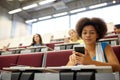 African student girl with smartphone at lecture Royalty Free Stock Photo