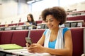 African student girl with smartphone at lecture Royalty Free Stock Photo