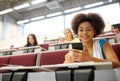 African student girl with smartphone at lecture Royalty Free Stock Photo