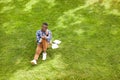 African Student Sitting on Grass Royalty Free Stock Photo