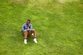 African Student Sitting on Lawn Royalty Free Stock Photo