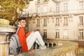 African student sitting on the street of Paris