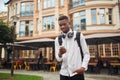 African man walking and looking at electronic map in smart phone.