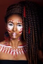 African style . Attractive young woman in ethnic jewelry . close up portrait of a woman with a painted face. Creative make up Royalty Free Stock Photo