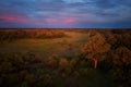 African sunset, atmospheric view from above on trees of Moremi forest, Botswana. Typical ecosystem, part of Okavango delta, aerial