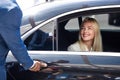 African taxi driver opening the door of car Royalty Free Stock Photo