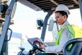 African technician worker woman stay on tractor and look to some directions and action of thinking to her work Royalty Free Stock Photo