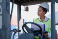 African technician worker woman stay on tractor and look to some directions and action of thinking to her work Royalty Free Stock Photo