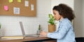 African teen girl student wear headphones watching webinar class making notes. Royalty Free Stock Photo