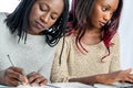 African teen students working together at desk. Royalty Free Stock Photo