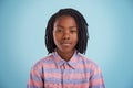 African teenager, face and fashion in studio with creative, style and confidence on a blue background. Portrait of young Royalty Free Stock Photo