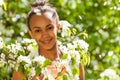 African teenager girl with flowers on pear tree Royalty Free Stock Photo