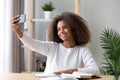 African teenager girl sitting at desk make selfie photo