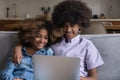 African teenagers couple spend free time on internet using laptop Royalty Free Stock Photo