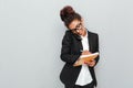 African thinking business woman over grey wall Royalty Free Stock Photo