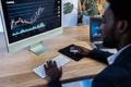 African trader studying stock market at home - Focus on computer screen