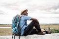 African traveler man sitting and lying with backpack on view of mountain background