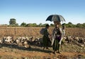 African tribe girls walking along road in ethiopia