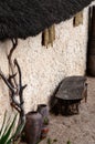 African village outdoor scene empty bench and pots straw roof Royalty Free Stock Photo