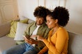 African Wife Pointing At Smartphone Browsing Internet Together At Home Royalty Free Stock Photo