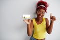 African woman with afro hair hold Abia flag isolated on white background, show thumb up. States of Nigeria concept