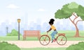 African woman on bicycle rides around city. Spring landscape. Summer background. Cute happy young girl on bike at park Royalty Free Stock Photo