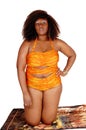 African woman in bikini kneeling. Royalty Free Stock Photo