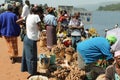 African woman buys sweet potatoes.