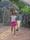 African woman carry wood