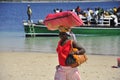 African woman carrying luggage on the head