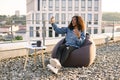 African woman in casual shirt using phone while recording video for her vlog. Royalty Free Stock Photo