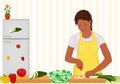 African woman cooking salad in the kitchen Royalty Free Stock Photo