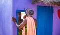 African woman doing her makeup outdoors Royalty Free Stock Photo