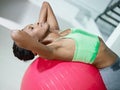 African woman doing series of sit-ups in gym Royalty Free Stock Photo