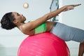 African woman doing series of sit-ups in gym Royalty Free Stock Photo