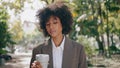 African woman drinking coffee standing city park closeup. Girl enjoying beverage Royalty Free Stock Photo