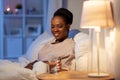 african woman drinking water in bed at night Royalty Free Stock Photo