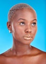 African woman, face and creative makeup, beauty and cosmetics for skincare or natural skin glow on studio blue Royalty Free Stock Photo