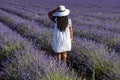 African Woman in a field of lavender flowers