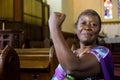 African woman flexing arm muscles in show of feminist power