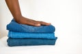 African woman folding stack of jeans or denim isolated on white background Royalty Free Stock Photo