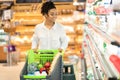 African woman on grocery shopping in supermarket walking along shelves Royalty Free Stock Photo