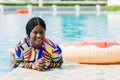 African woman happy relax at swimming pool summer holiday travel vacations. Black tourist girl swimming at luxury resort