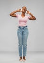 African woman in headphones listening to music Royalty Free Stock Photo