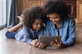 African woman her little daughter using digital tablet at home Royalty Free Stock Photo
