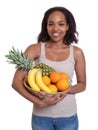 African woman holding a basket of fruits Royalty Free Stock Photo