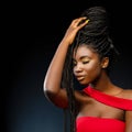 African woman holding braids with eyes closed. Royalty Free Stock Photo