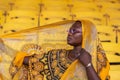 African woman holding in her head shawl Royalty Free Stock Photo