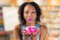 African woman holding rose blossom Royalty Free Stock Photo