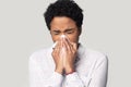 African woman holding tissue blowing running nose studio shot Royalty Free Stock Photo